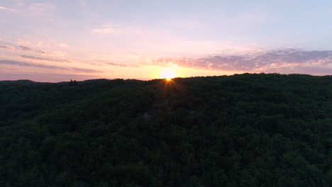 aerial drone sunrise over a forest in france.