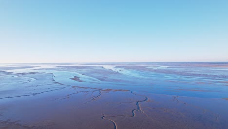 low tide by the shore of bassin d'arcachon with mudflats in gujan-mestras, gironde, france