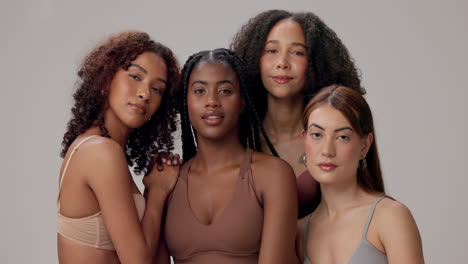 four diverse women smiling together