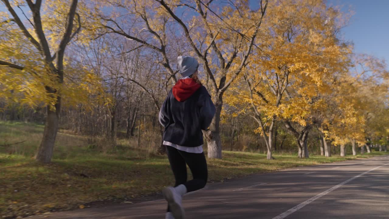 가을 공원에서 달리는 여자