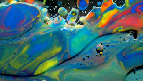 slow motion bright colors bubbles oil beautiful paint universe color moving multicolored closeup. acrylic paint. fantastic surface. abstract colorful paint metamorphosis structure colorful bubbles