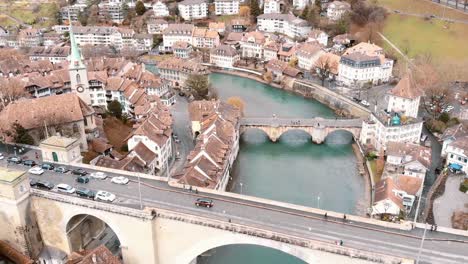 Fly-over-Nydegg-and-Untertor-Bridges-across-Aare-River,-Bern-Switzerland