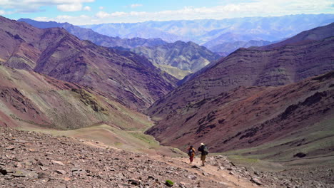 wide shot of the himalayan mountain range with hiking people, backpackers on the road