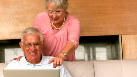 Senior-man-using-laptop-on-couch