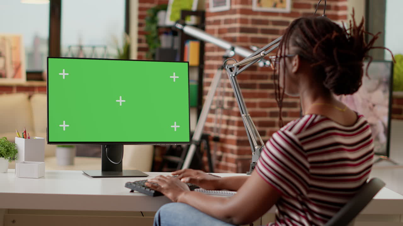 Woman Working on Computer with Green Screen