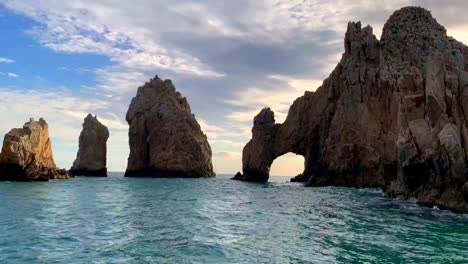 wide, sunset of beautiful, famous cabo san lucas sea arch el arco at land's end promotory, playa del amor at cabo san lucas, baja california sur, mexico in 4k, static shot