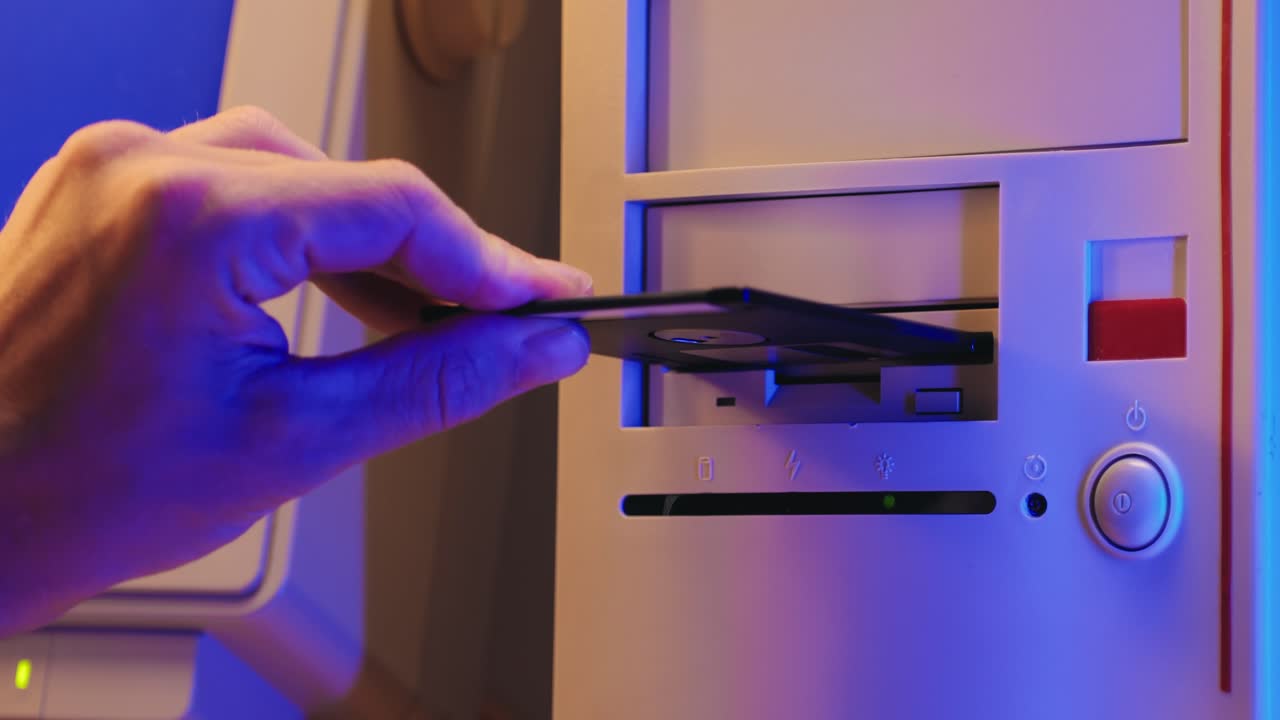 Using diskette for old computer. Music recorder, playing retro computer games. Vintage device for office, obsolete technology. . High quality 4k footage