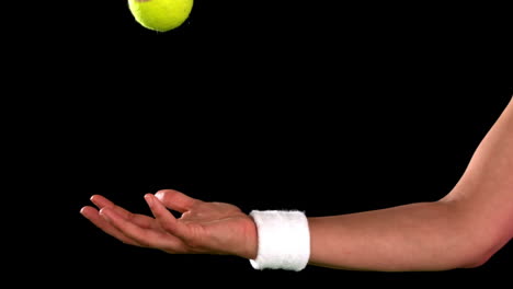 tennis player throwing and catching ball