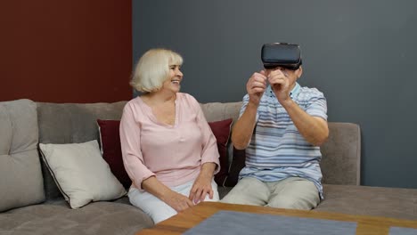 grandfather and grandmother with vr headset helmet play games, watch virtual reality 3d 360 video