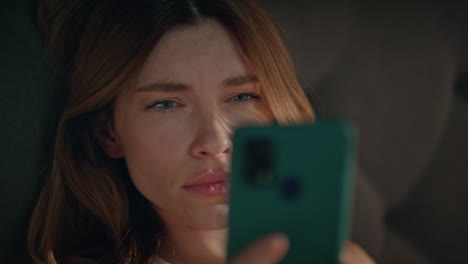 tired girl waking bed looking smartphone closeup. unhappy woman feeling headache