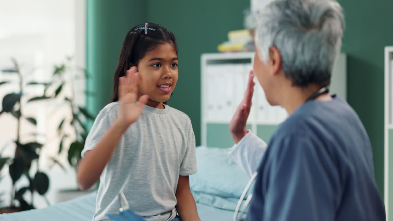 Doctor giving high five to young patient