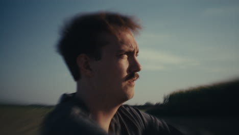 a man in motion with a blurred outdoor background