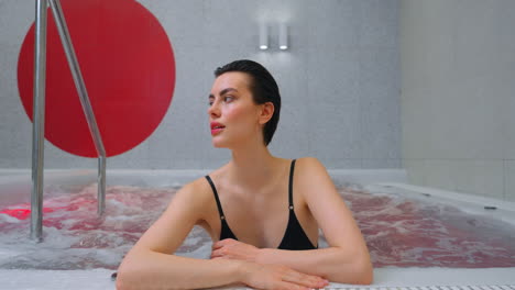 woman relaxing in a modern spa hot tub