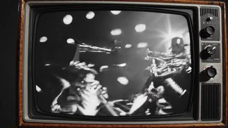 aliens playing trumpets on a vintage tv