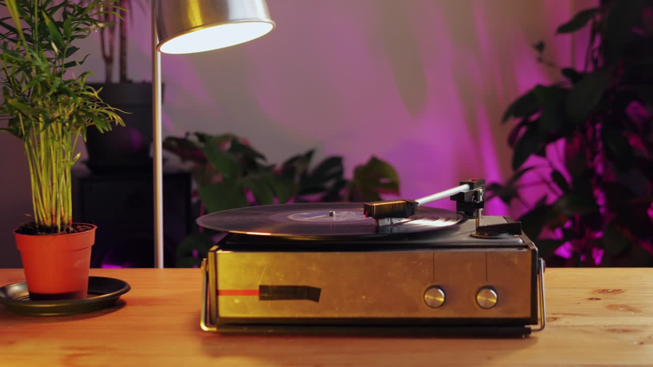 Retro Vinyl record player playing music, close-up macro shot of vintage LP disc old phonograph spinning. Retro music player.