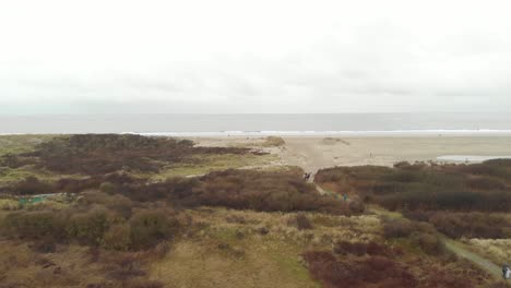 People-walking-to-a-beach-on-Ameland-island-in-The-Netherlands,aerial