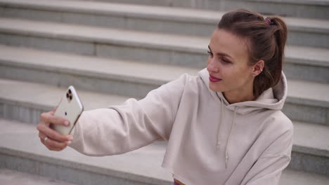 woman taking a selfie on steps