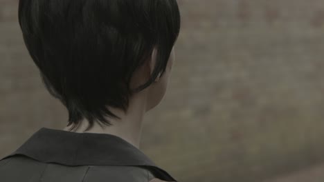 close up of woman walking nervously down an ally way.