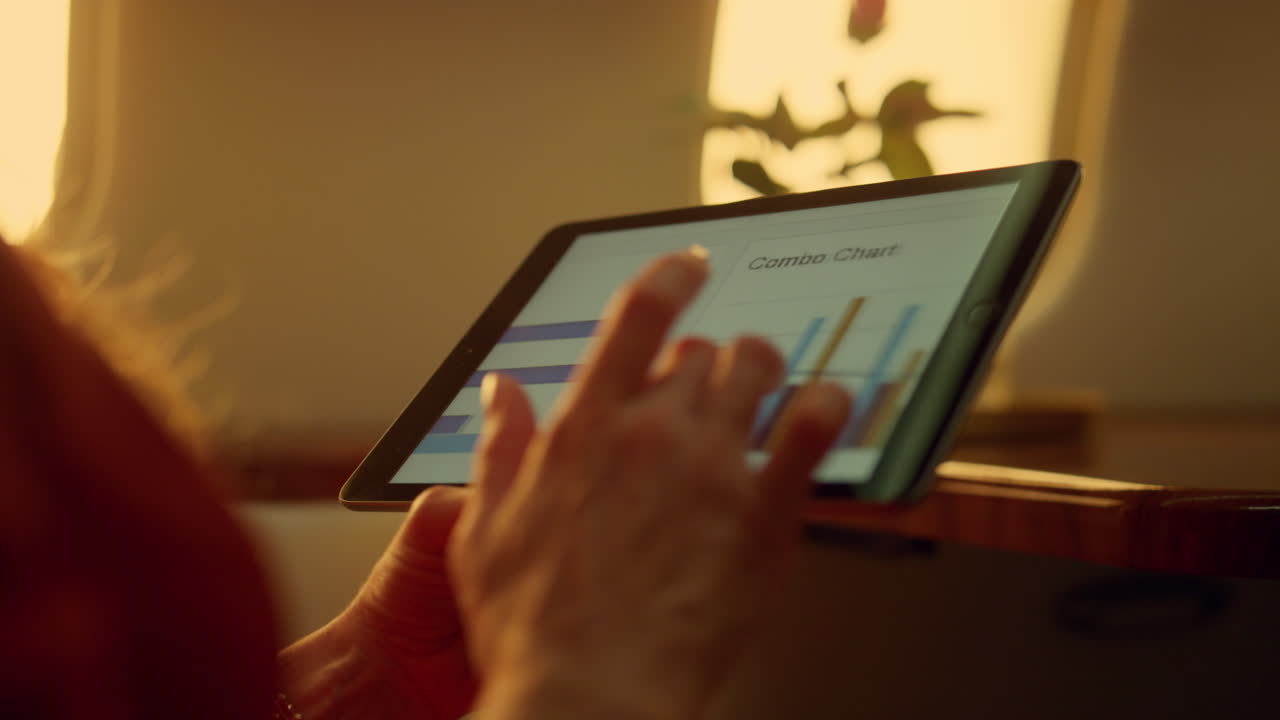 Corporate manager browsing tablet charts on airplane. Hands touching pad closeup
