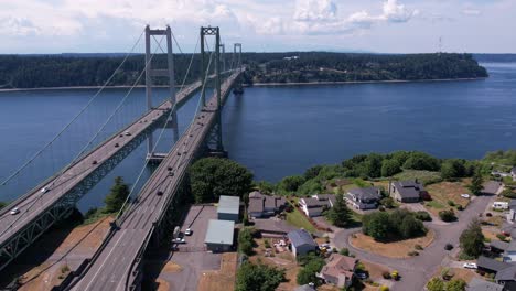 Rushing-traffic-over-the-Tacoma-narrows-bridge-during-rush-hour,-aerial-hyper-lapse-track-back