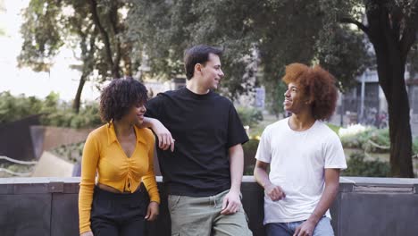 Happy-multiethnic-friends-having-conversation-on-street