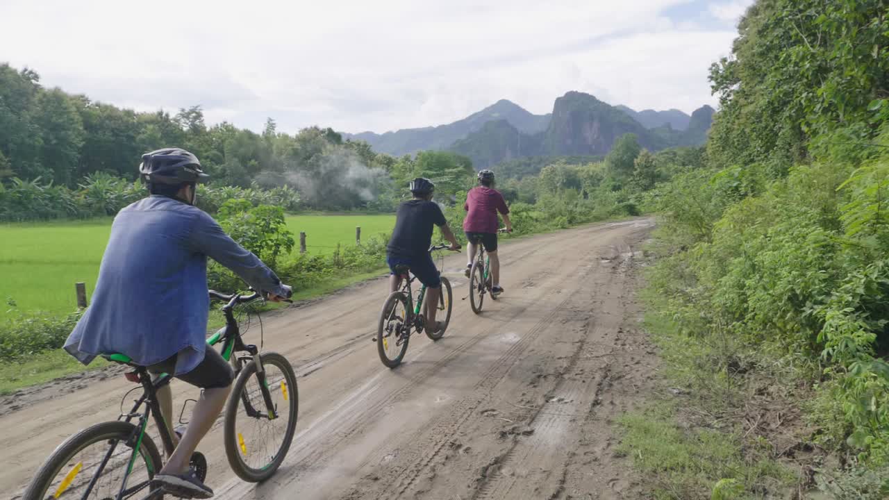 Friends Cycling Through Countryside