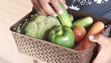 person holding a basket of vegetables