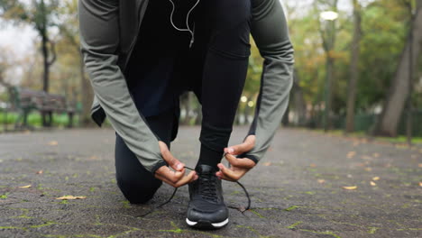 hands, shoe tie and running outdoor in a park