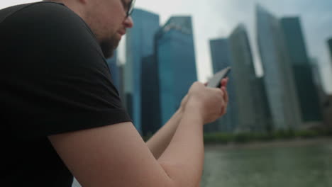 man using phone in singapore city