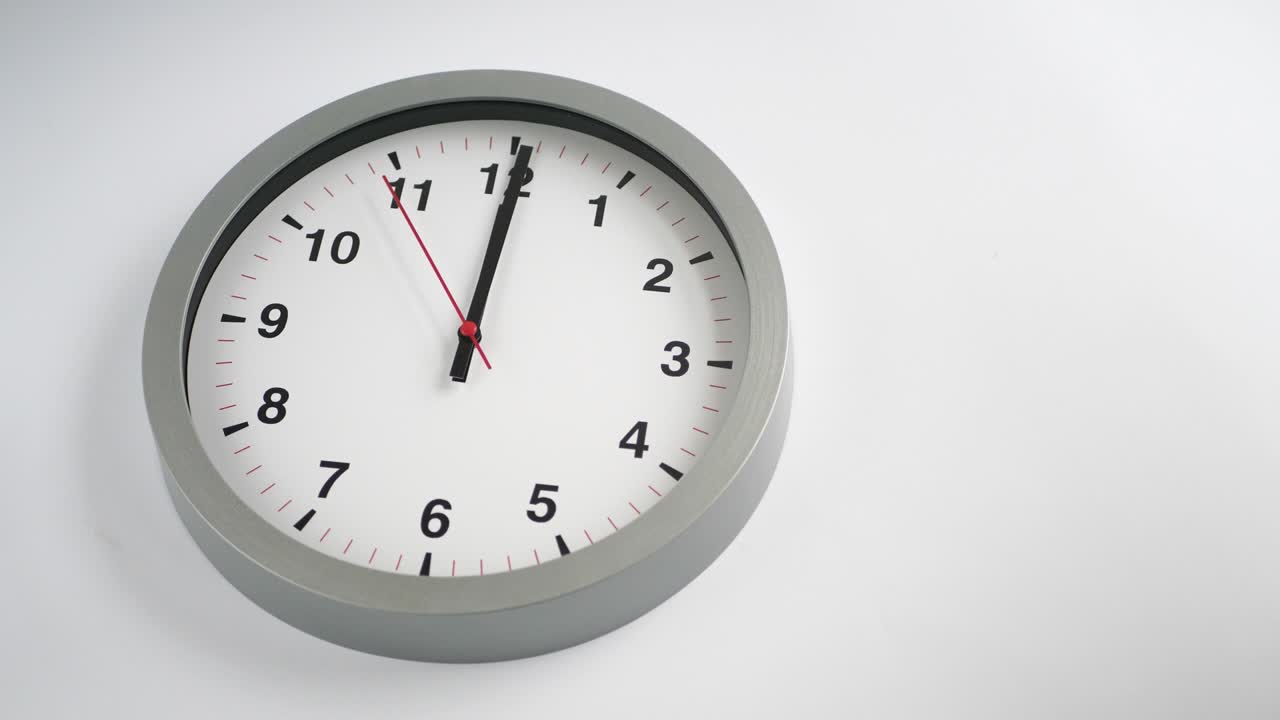 Orologio che ticchetta su sfondo bianco, spazio per il testo, time lapse.