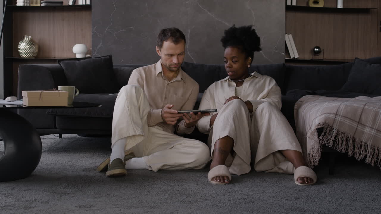 Couple using tablet at home