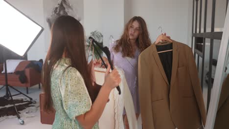 women trying on clothes in a photo shoot