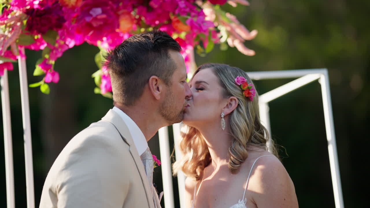 Slow Motion Bride And Groom Kissing At Colorful Floral Wedding Altar, 4K Resolution