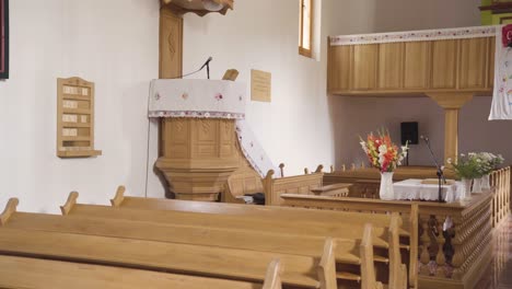 Inside-empty-reformed-church,-view-of-front-pulpit,-rows-of-pews