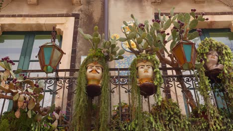 charming pair of sicilian moorish heads with hanging plants and cactus in taormina, sicily, italy (sicilia, italia), capturing mediterranean essence