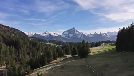 Amden-Arvenbüel's-lush-meadows-against-the-Swiss-alpine-skyline---aerial