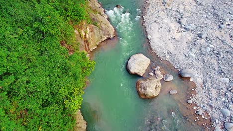 the river that flows between the rocks of the mountains