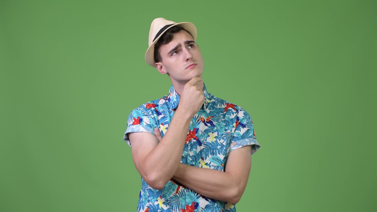 Young handsome tourist man thinking