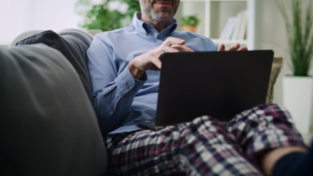 Tilt up video  of man gesturing during a video conference