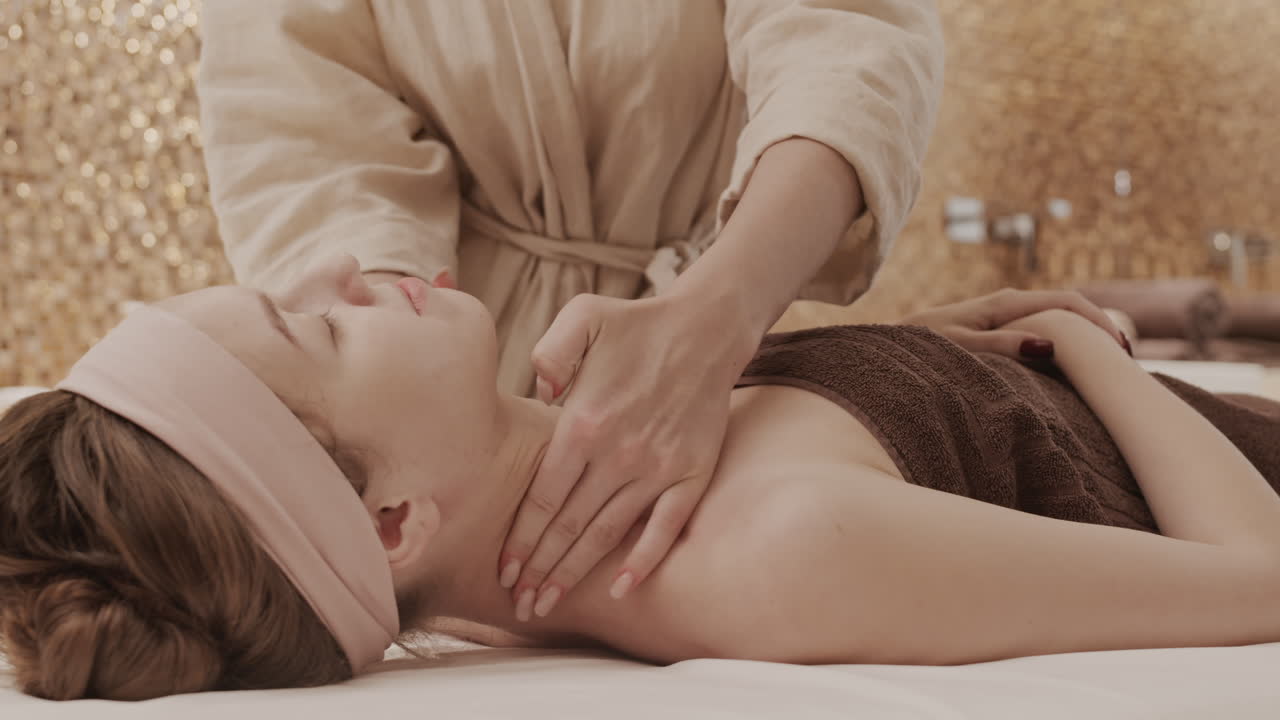 Woman receiving neck and shoulder massage at spa