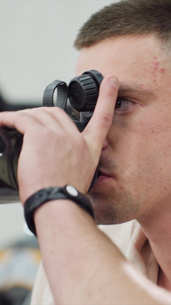 Close up on side profile focusing on facial features. subject is partially obscured by equipment in some frames but remains consistent as man with visible skin texture and acne