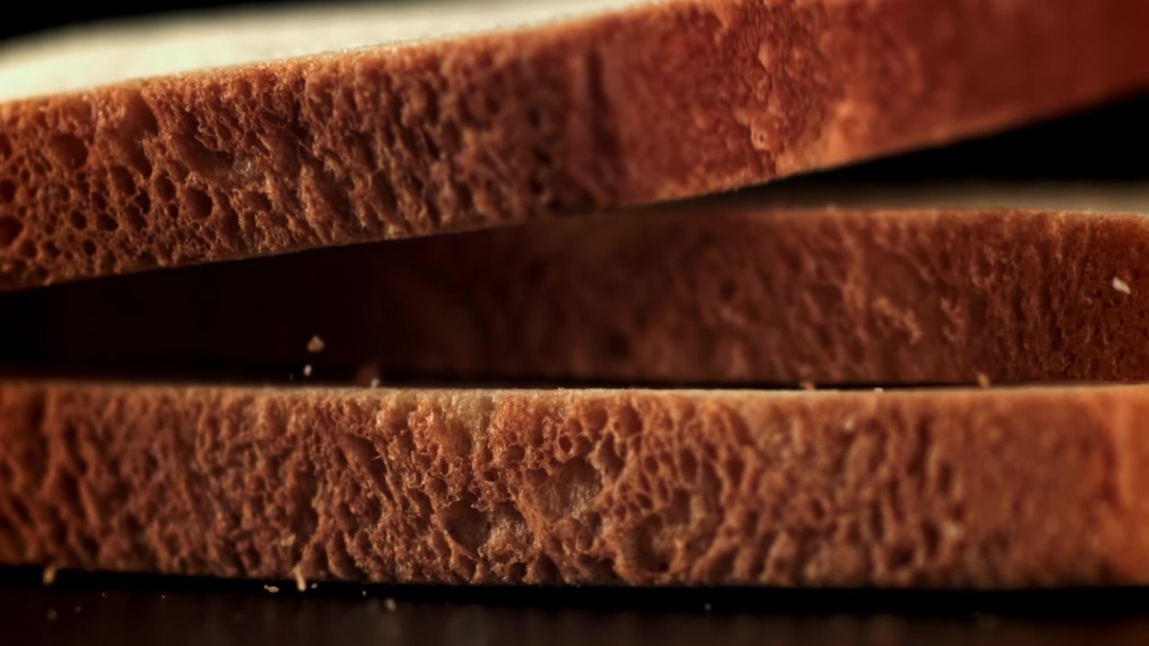 Slow Motion Close-Up of Slices of Bread Falling and Stacking