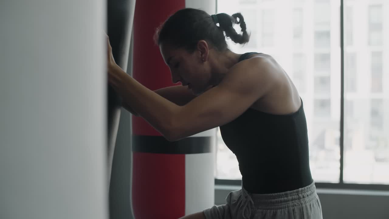 Woman working out with punching bag