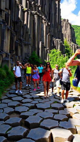 people hiking through basalt columns