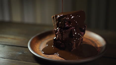 dark chocolate flowing on brownie cake. chocolate dripping on delicious dessert