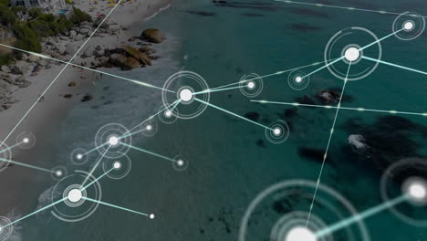 animación de conexiones de red sobre vista aérea de la playa y el océano