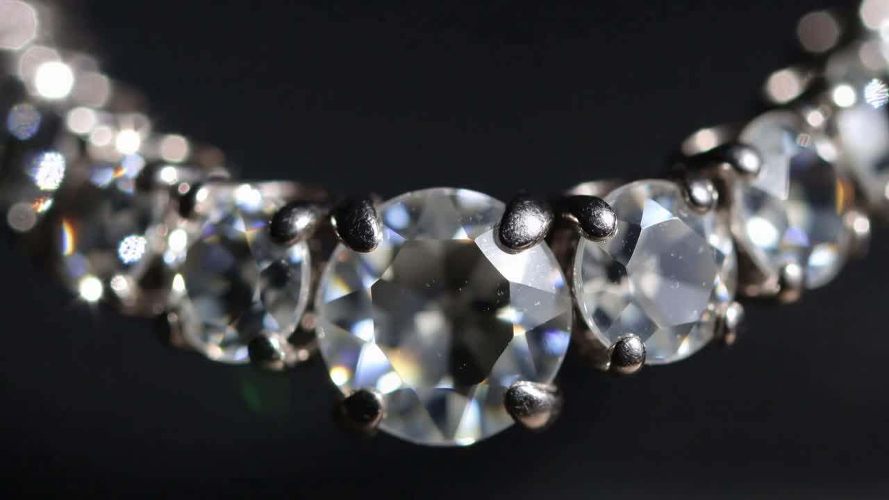 Tilting camera revealing center round gemstone and side stones under lights for sparkle