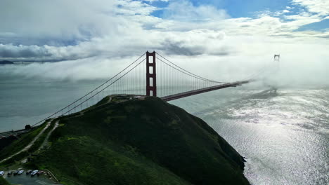 breathtaking scene as golden gate bridge pierces through clouds on a misty day