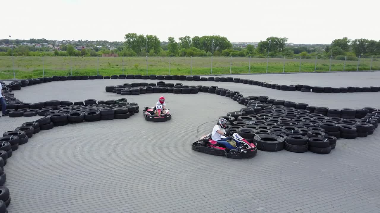 Drivers In Karts Participate In Kart Race. VINNITSA, UKRAINE - MAY 2017: Europe Day, men drive karting car on outdoor track
