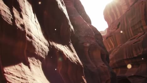 a captivating journey through sunlit canyons, where golden dust dances in the warm air beneath towering red sandstone cliffs, enhancing the beauty of nature's artistry